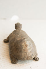 Rear view of the vintage tortoise sculpture showing its hand-carved geometric shell.