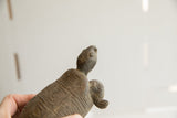 Upward-looking profile of the vintage tortoise sculpture showing its handmade texture.