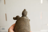 A view from behind the vintage tortoise sculpture showing its hand-carved shell.