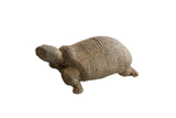 Vintage handmade tortoise sculpture with a weathered earthen texture and a geometric carved shell.