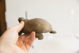 Vintage tortoise sculpture held in hand showing its scale and carved shell.