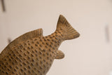 Carved details of the tail fin and raised scales on the vintage African fish.