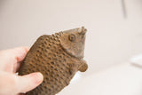 Handmade details of a vintage African fish sculpture, highlighting its rustic scales and aged patina.