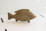 Detailed profile of a vintage African fish sculpture showing hand-carved scales.