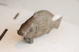 Vintage African fish sculpture head with aged patina and intricate scales.