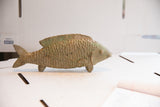 Vintage African fish sculpture with carved scales, fins, and a rustic, earthy patina.