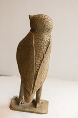 Back view of the vintage owl sculpture showing its carved wings and textured body.