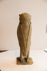 Vintage African owl sculpture showing textured back and carved wing detail.