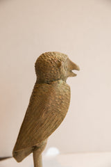 Detailed view of the vintage African owl sculpture's green-brown patinated surface and carved wings.