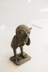Close-up of the vintage owl sculpture's head, showing its bumpy texture and carved eyes.