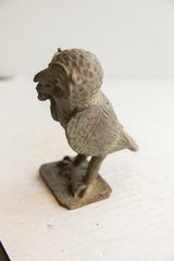 Side profile of the vintage African owl sculpture showing its hand-carved wing and head.