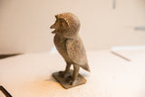 Side profile of the vintage African owl sculpture showing its handmade charm and rustic texture.