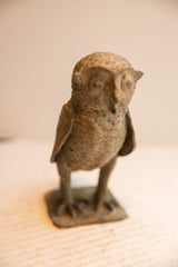 High-angle view of the vintage African owl sculpture's textured form.