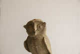 Vintage African owl sculpture's rough, handmade texture and expressive eyes.