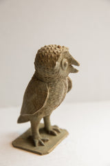 Textured feet and rectangular base of the vintage African owl sculpture.