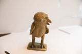 Side profile of the vintage owl sculpture, detailing its bumpy head texture and beak.
