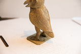 Side profile of a vintage African owl sculpture showing its textured, hand-carved wing.