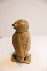 Hand-carved wings and textured body of the vintage African owl sculpture, viewed from behind.