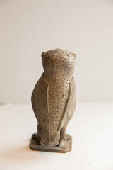 Back view of the vintage owl sculpture showcasing its carved wings and rustic, textured surface.