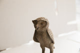 Close-up of the vintage African owl sculpture's face, revealing its textured, handmade character.