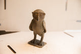 Vintage African owl table accent with a detailed, rustic texture and direct gaze.