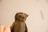Close-up of the vintage African owl's face showing its round eyes and handmade texture.