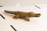 Side profile of the handmade African crocodile showing its ridged body and spiny tail.