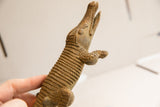Angled view showing the handmade texture of a vintage brass crocodile's body and open jaw.