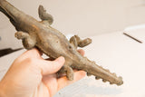 The textured underbelly and legs of the vintage African crocodile sculpture.