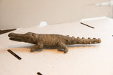 Side view of the vintage African crocodile sculpture showing its detailed hand-carved body.