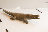 Vintage African crocodile sculpture with deeply textured body and open jaw.