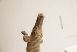 Patinated vintage African crocodile sculpture head, looking up, showing textured scales.
