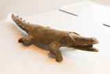 Handmade African crocodile sculpture with carved body details and earthy brown patina.