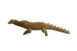 Hand-carved vintage African crocodile sculpture with textured scales holding a fish in its mouth.