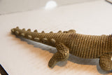 Hand-carved grid pattern and ridged spine on the vintage crocodile sculpture's back.