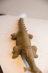 The long, ridged spine and scaled texture of the vintage crocodile sculpture.