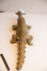 Overhead view focusing on the textured, scaled back of the vintage African crocodile sculpture.