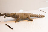 Side profile view of the carved vintage African crocodile sculpture.