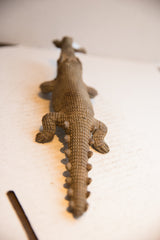 Overhead view of the carved scales and spiny tail on the vintage crocodile sculpture.