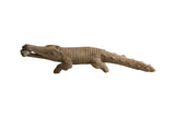 Vintage African crocodile with fish sculpture, showing hand-carved details and a weathered patina.