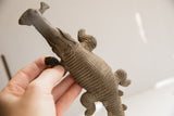 Underside of the vintage African crocodile sculpture showing its detailed carved texture.