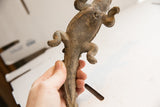 Vintage African crocodile sculpture held in hand, showing the textured underbelly and legs.