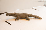 Side view highlighting the carved scales of the vintage crocodile sculpture.