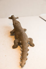 Detailed carving of scales and ridges along the back of the vintage crocodile sculpture.