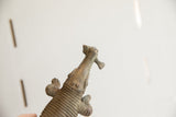 Angled view of the vintage African crocodile sculpture's head holding a fish.