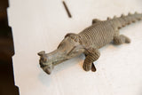 Aged patina and textured detail on the head of a vintage African crocodile sculpture.