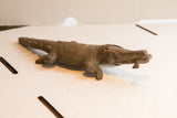 Side profile of the vintage African crocodile figure showing its full length and carved texture.