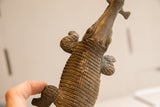 Vintage African crocodile sculpture held to show its hand-carved texture and scale.