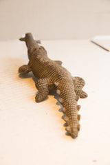 View along the back of the African crocodile sculpture showing its hand-carved texture.