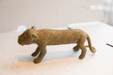 The vintage cheetah sculpture's distinctive stamped circle pattern seen in profile.